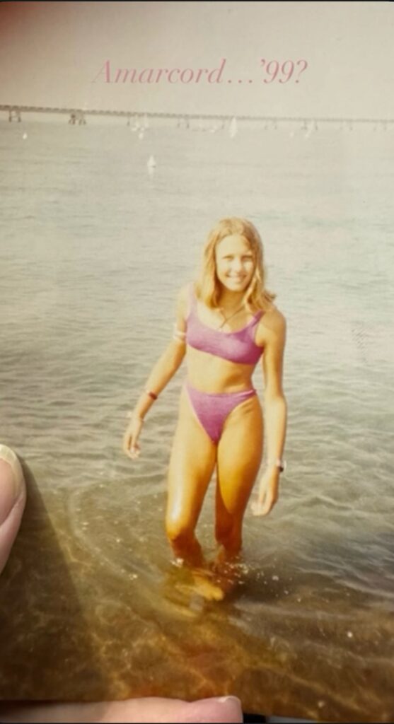 Old printed photo: girl in a pink bikini by the sea