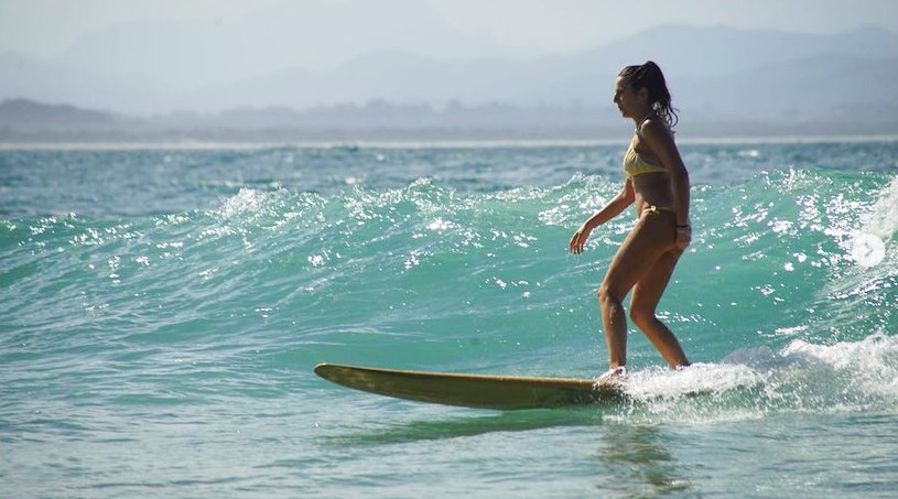 Surfer in a bikini on a green wave