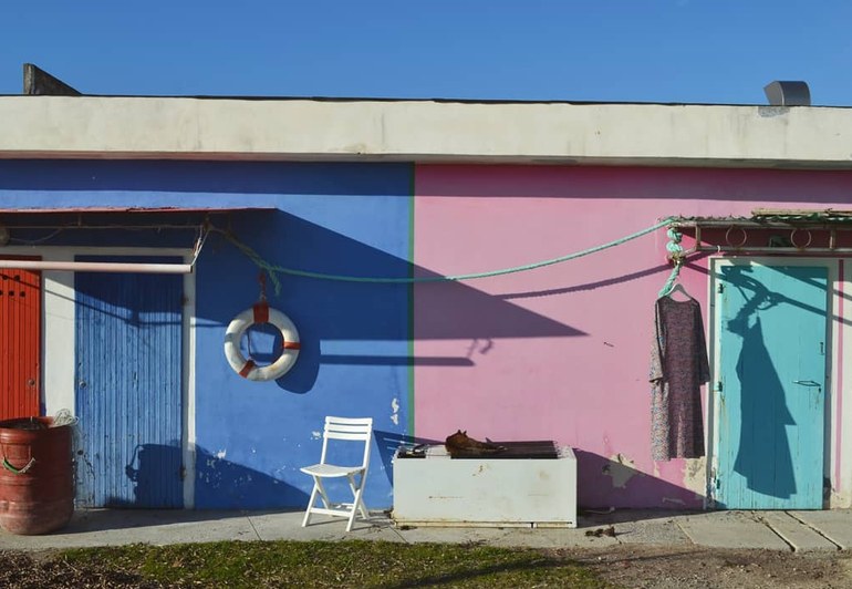 Colorful beach cabins with a dress hanging