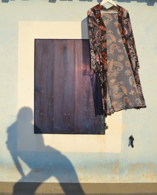 Kimono hanging next to a window