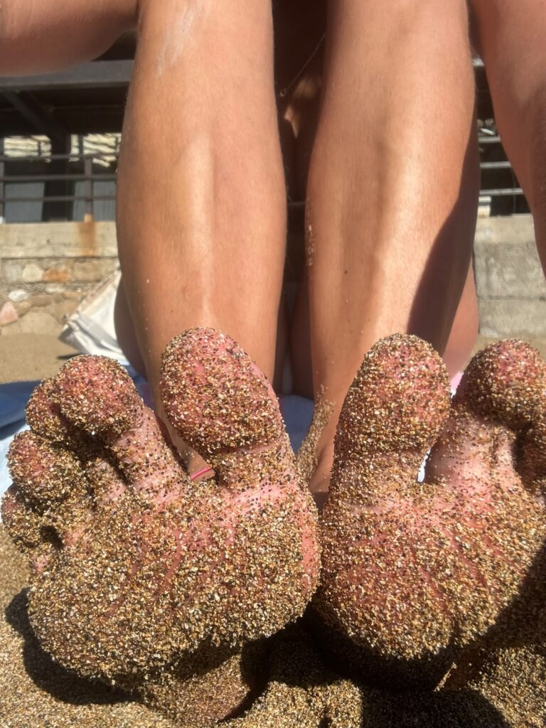 Feet covered in sand
