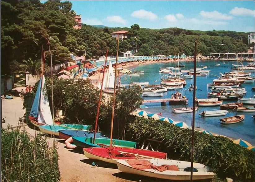 Bay with boats and beach umbrellas, vintage photo