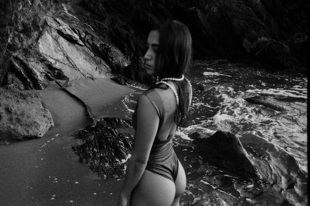 Girl in a swimsuit among the rocks, black and white